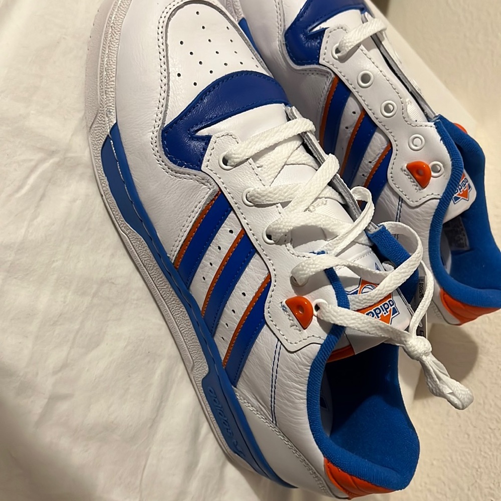 ****Sold**** RIVALRY LOW
Whit Blue and orange size 9.5 NWT